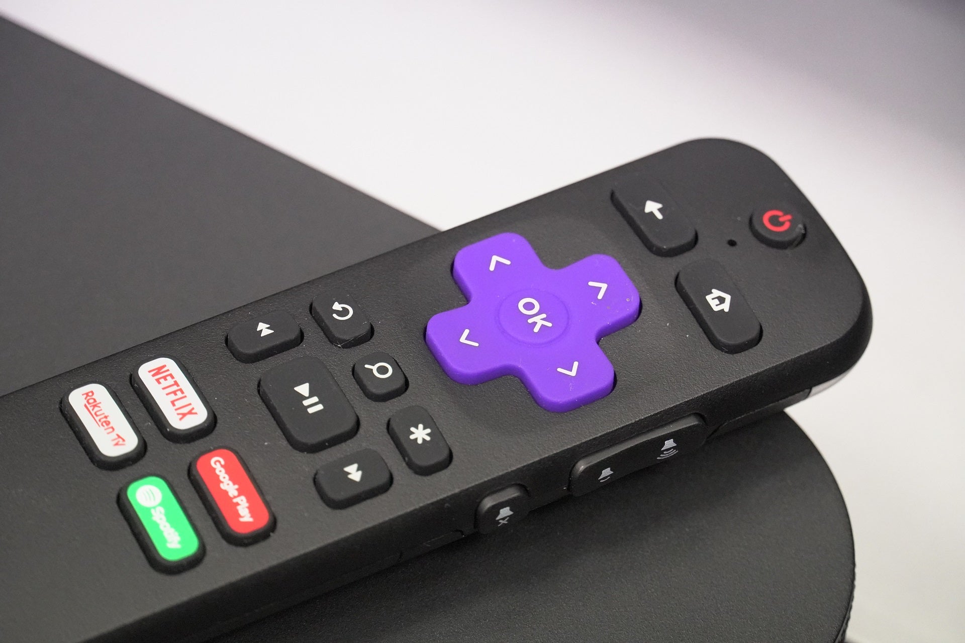 A user holding an Insignia TV Remote, a sleek device designed for controlling Insignia TVs with features such as volume control, power functions, input selection, and advanced capabilities like voice commands, providing a convenient and seamless user experience