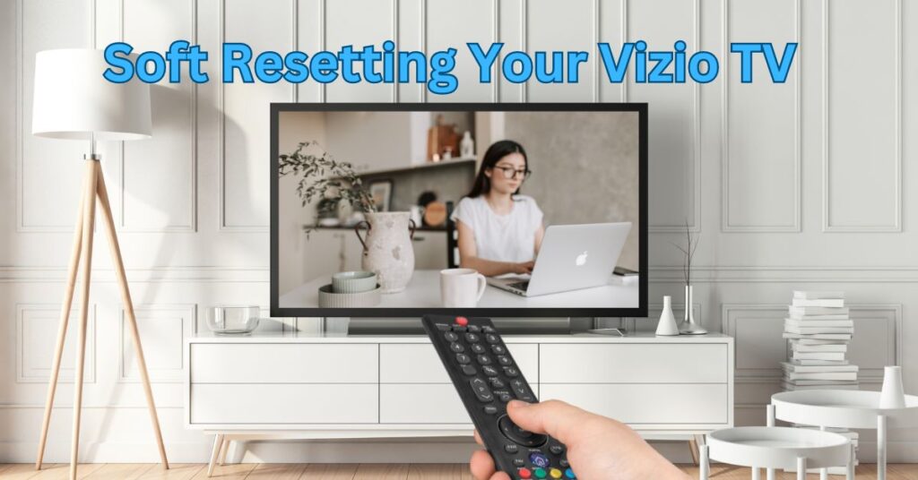 Image depicting a hand holding a Vizio TV remote, pressing the reset button gently, symbolizing the soft reset process for Vizio TVs.